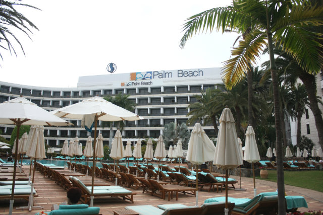 Seaside Palm Beach hotel building & parasols